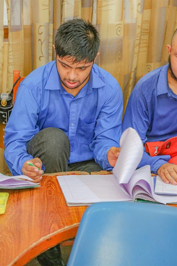 Two students studying together over their notebooks